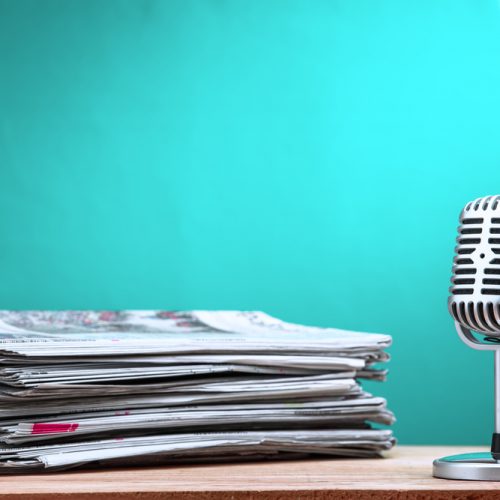 Retro,Microphone,With,Newspaper,On,Wooden,Table,-,Announcement,Concept